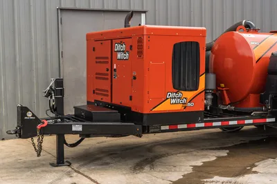2023 Ditch Witch HX50 mud mixing unit on trailer, side view showing engine enclosure, cooling vents, HX50 decal, and vacuum tank.