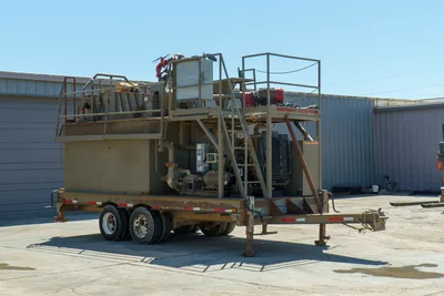 2018 Mud Technologies MCT-450 trailer-mounted mud recycler, rear 3/4 view, dual-axle trailer, upper deck walkway, staircase, pumps, piping