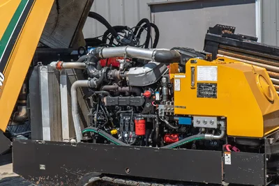 2020 Vermeer D24x40 S3 open engine compartment showing 125hp diesel engine, turbo, hydraulic pump, cooler, and drill pipe rack