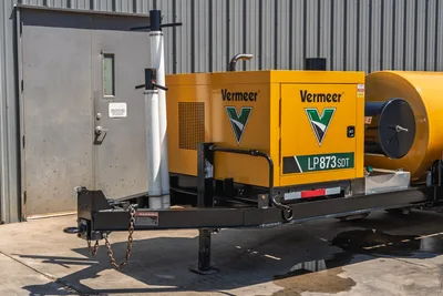 2025 Vermeer LP873SDT trailer-mounted vacuum excavator, front hitch and tongue assembly, yellow engine enclosure, debris tank visible