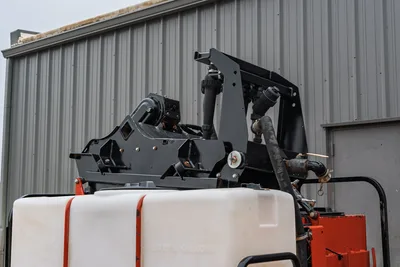 2015 Ditch Witch MR90 mud recycler pump assembly, manifold plumbing, hose connections, and white water tank, close-up angle