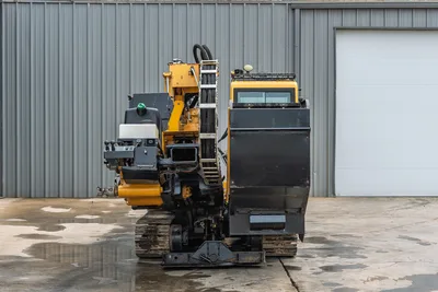 Rear view of 2017 Vermeer 40x55 S3 HDD drill showing pipe rack, hydraulic hoses, operator cab, and steel tracks.