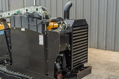 2018 Vermeer D8x12 HDD engine compartment, black radiator housing, exhaust stack, hydraulic lines, drill carriage visible top-left