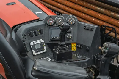 2018 Ditch Witch JT20 operator station featuring ESID display, joystick controls, instrumentation gauges, and drill pipe rack.