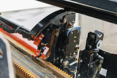 2015 Ditch Witch JT20 drill frame close-up showing rack-and-pinion gear, carriage assembly, vise components, and hydraulic fittings