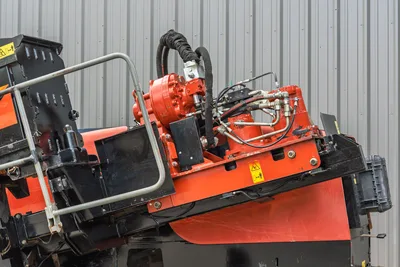 2021 Ditch Witch JT28 drill frame close-up showing rotary drive head, hydraulic lines, fittings, and angled carriage assembly