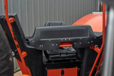 2021 Ditch Witch JT40 operator station close-up showing black control console, seat, orange ROPS frame, and work light