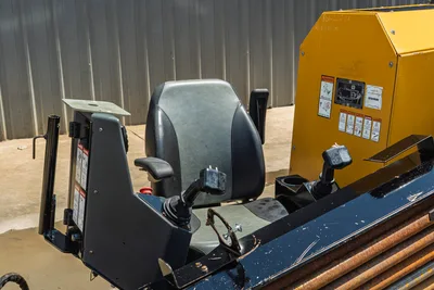 Vermeer 10x15 S3 HDD unit operator cab with controls, yellow power unit, drill pipe visible, side view
