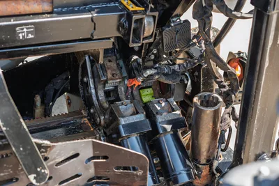 2022 Ditch Witch JT20 close-up of carriage drive system, hydraulic cylinders, rack gear, and spindle components showing wear