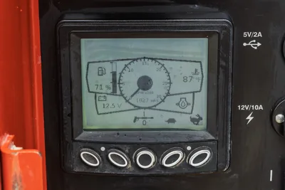 Ditch Witch HX50 digital display panel showing 1,827 hours, 71% fuel, 12.5V battery, 87°F temp, with USB and 12V ports