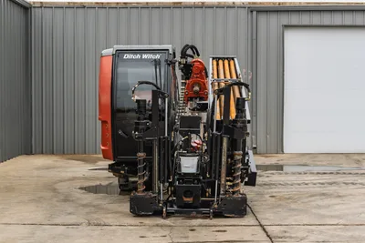 Front view of 2021 Ditch Witch AT40 All Terrain HDD drill showing enclosed cab, drill rack, pipe, and stabilizer legs.