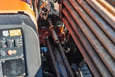 Ditch Witch JT10 control panel, rotary head, and stacked 1.66" drill pipe with worn operational surfaces