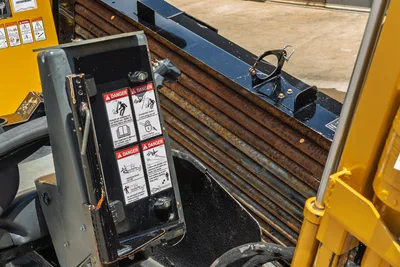 Vermeer 10x15 S3 HDD drill pipe bundle with clamp attachment, control panel, and safety labels visible