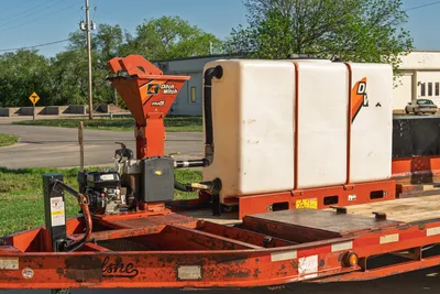Belshe WB14-2EP trailer, side view of Ditch Witch FM5 mixer, white tank, engine, visible wear.