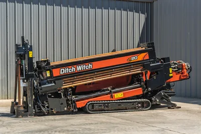 2021 Ditch Witch JT20 horizontal directional drill, side view, showing tracks, pipe rack, drill string, and carriage frame.