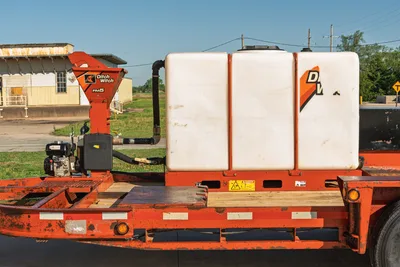 Angle: Belshe WB14-2EP trailer side view w/ Ditch Witch FM5x mixing system, white tank, engine, pipes.