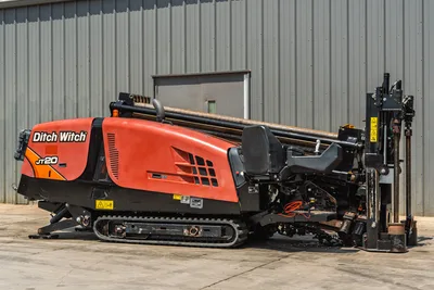 2021 Ditch Witch JT20 HDD drill, 3/4 side view, orange hood, rubber tracks, loaded drill pipe, drill frame raised