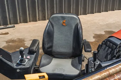 2023 Ditch Witch JT20 operator seat with branded logo, dual joystick controls, armrests, and control panel; used condition