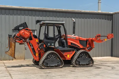 2024 Ditch Witch RT125Q ride-on trencher, 3/4 view, rubber tracks, enclosed cab, chain trencher boom left, RC30 backhoe right