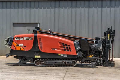 2017 Ditch Witch JT20 HDD rig, full left-side profile, rubber tracks, drill pipe loaded, angled drill frame, operator controls visible