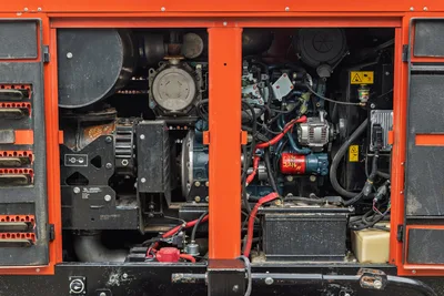 2023 Ditch Witch HX75 mud recycler open engine compartment showing diesel engine, alternator, battery, pump drive, and wiring harness