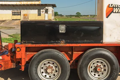 2016 Belshe WB14-2EP trailer side view; black toolbox, tandem axles, Ditch Witch mix system partially visible.