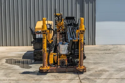 2019 Vermeer D40x55 S3 HDD drill, rear view showing vise assembly, anchor posts, drill pipe rack, and hydraulic components