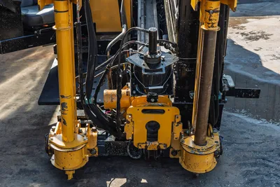 2016 Vermeer D23x30 S3 drill frame close-up showing carriage, rotary drive, hydraulic lines, and anchor posts