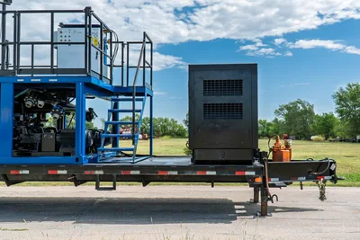 2023 American Augers M300DH mud mixing system on trailer, blue frame, upper deck, stair access, pump components, black engine enclosure