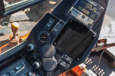 2014 Ditch Witch JT100 Mach 1 operator cab interior showing ESID panel, pressure gauge, toggle switches, and gear shift