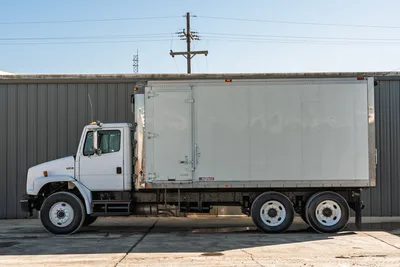 Profile view of 2000 Freightliner FL80 box truck with white cab, tandem rear axles, and Morgan aluminum body unit.