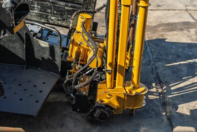 2016 Vermeer D23x30 S3 rear anchor assembly with yellow hydraulic cylinders, hoses, and wear-worn components visible