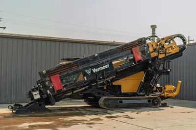 2017 Vermeer D100x140 S3 HDD drill, full side profile, drill frame elevated, loaded drill pipe, rubber tracks, mud pump visible