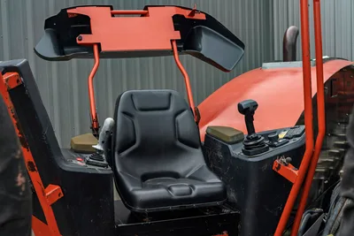 2021 Ditch Witch JT40 operator station showing black seat, dual joystick controls, ROPS canopy, and control panel