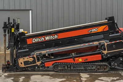 2018 Ditch Witch JT20 horizontal directional drill side profile with rubber tracks, drill carriage, and pipe rack.