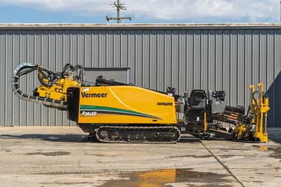 Side view of 2009 Vermeer D36x50 Series II HDD rig displaying track undercarriage, drill carriage, and open operator station.