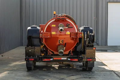 2022 Ditch Witch HX30 mud recycler, rear view, red spoils tank, suction port, hose reel, black poly water tanks, trailer-mounted