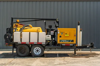2024 Vermeer LP573SGT vacuum excavator, side profile showing trailer, engine compartment, pump, and water tanks.