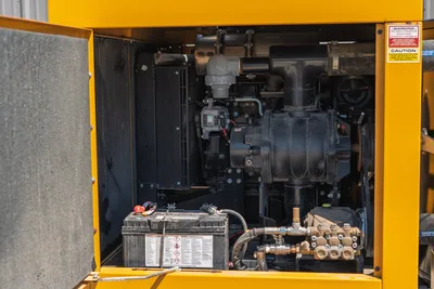 Vermeer LP873SDT vacuum excavator open engine compartment showing blower, high-pressure water pump, battery, and radiator