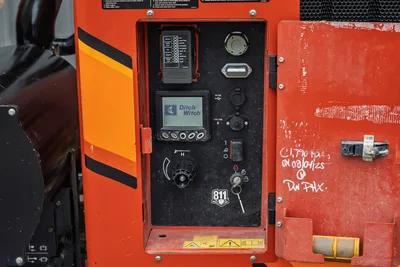 2021 Ditch Witch HX50 control panel with LCD display, fuse box, ignition switch, USB/12V ports, and flow knob
