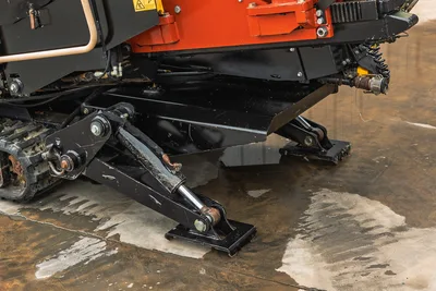 2018 Ditch Witch JT20 drill frame, hydraulic stabilizer legs, and rubber tracks; close-up of structural undercarriage.