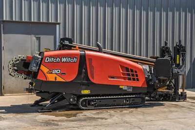 2022 Ditch Witch JT20 HDD rig, driver-side view, rubber tracks, loaded drill pipe, pipe carousel, thrust frame, operator controls visible