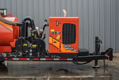 2021 Ditch Witch HX50 mud recycler on trailer, side view showing engine enclosure, vacuum pump assembly, hoses, and pintle hitch