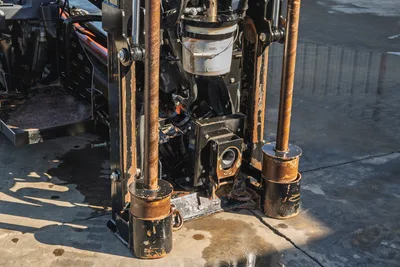 Ditch Witch JT20 HDD rig rotary head, drill pipe, and frame components in close-up detail view