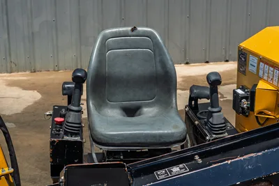 2021 Vermeer D8x12 operator seat with dual joystick controls, red emergency stop button, and hydraulic levers on black console