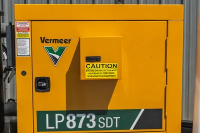Vermeer LP873SDT vacuum excavator yellow tank door panel with model decal, Vermeer logo, caution labels, and latch hardware