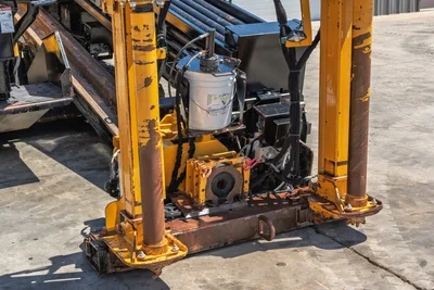 2019 Vermeer D40x55 S3 front anchor frame, vise assembly, and spindle close-up showing wear, hydraulic lines, and drill pipe rack above.