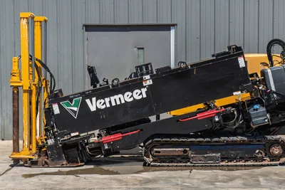2020 Vermeer D24x40 S3 HDD drill, side view showing black drill frame, angled carriage, rubber tracks, vise assembly, and pipe loader mast