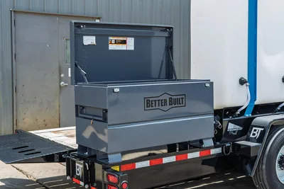 Behnke TBCT2220ET-BT-R trailer with open Better Built steel job box mounted on diamond-plate deck, Behnke-branded frame rail