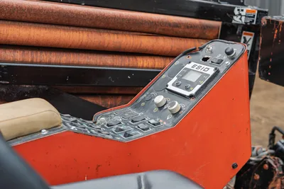 Ditch Witch JT4020 Mach 1 operator station control console, ESID display, and drill pipe rack in a side profile.